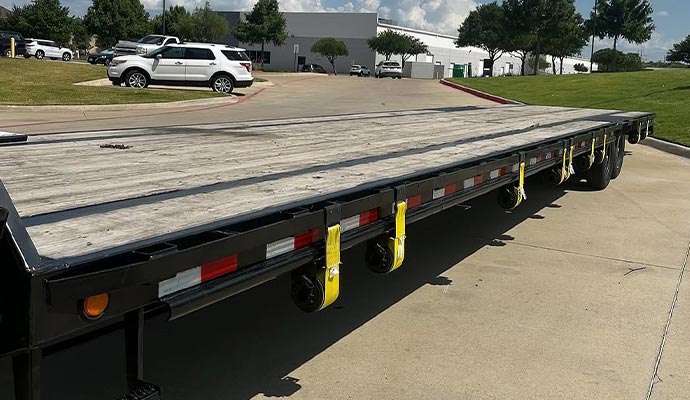 102 inch wide and 40 foot long gooseneck flatbed trailer parked on roadside