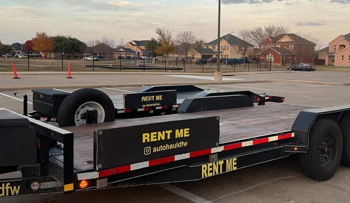 Empty gooseneck trailer parked and ready for hauling