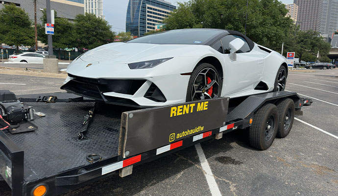 White Lamborghini Huracán convertible loaded on a 102-inch wide 20ft-long PJ SuperWide  car hauler trailer.