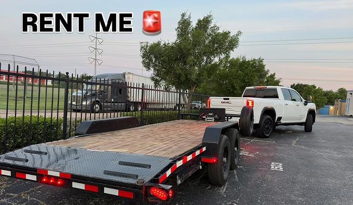 White pickup truck hauling a gooseneck trailer on the road