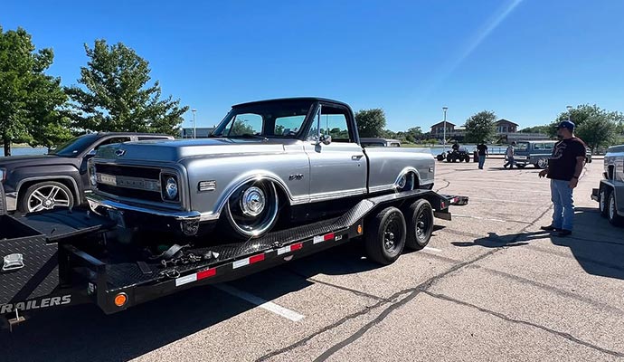 A Chevrolet C10 classic pickup truck loaded on a PJ flatbed trailer