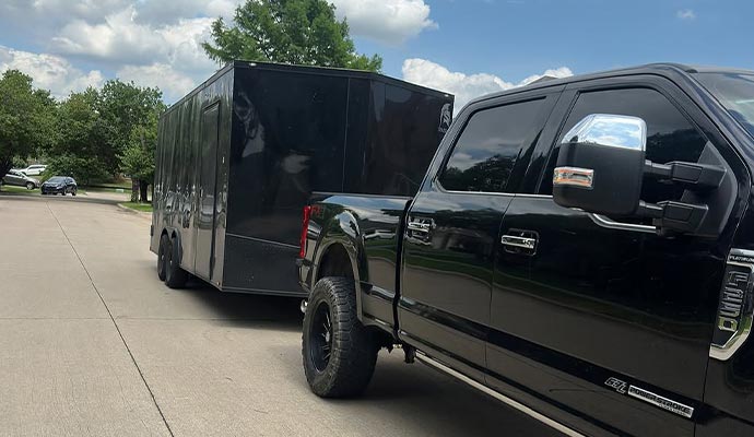 Moving trailer being hauled by a pickup truck on the road