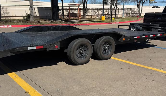 Black car hauler trailer with flatbed and tandem axles